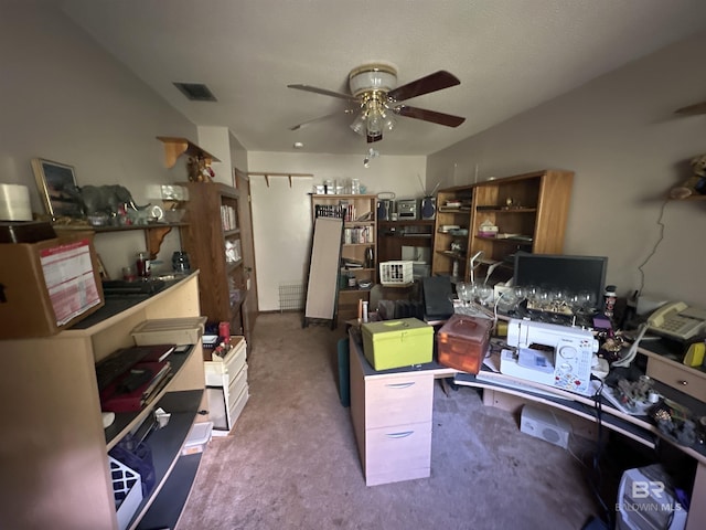 carpeted home office featuring ceiling fan