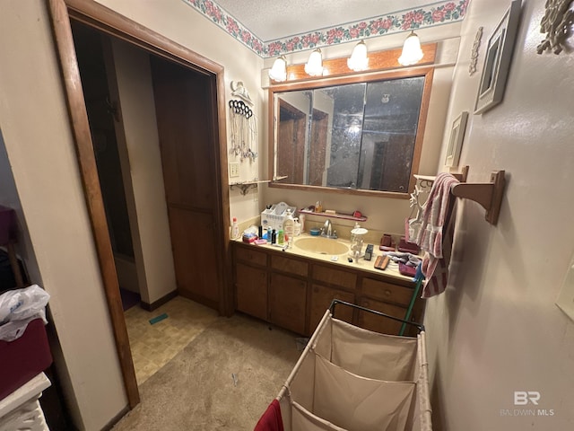 bathroom with vanity and a textured ceiling