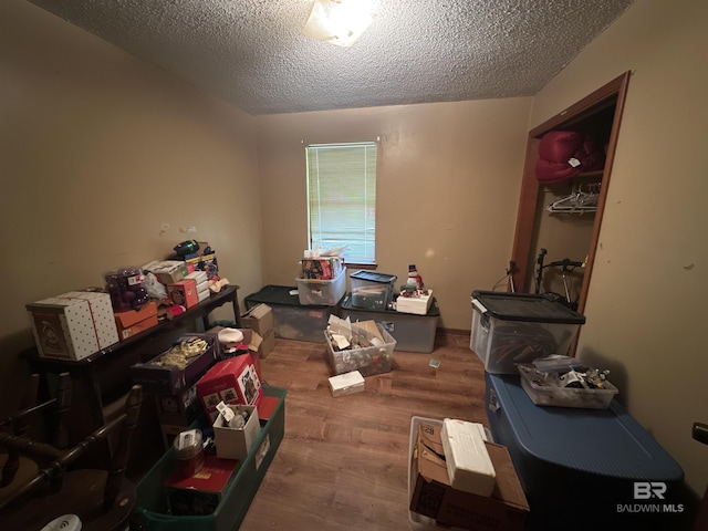 miscellaneous room featuring a textured ceiling and hardwood / wood-style flooring