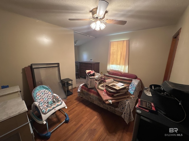 bedroom featuring a textured ceiling, hardwood / wood-style flooring, and ceiling fan