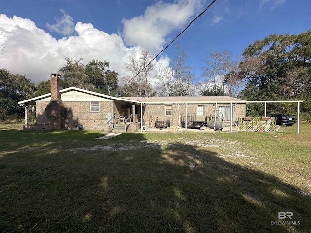 rear view of house with a lawn