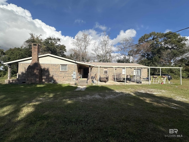 rear view of property with a yard