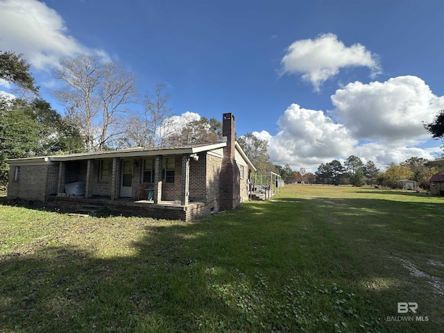 view of side of home featuring a lawn