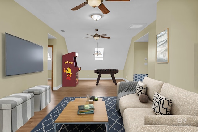 living area featuring wood finished floors, baseboards, a ceiling fan, and visible vents