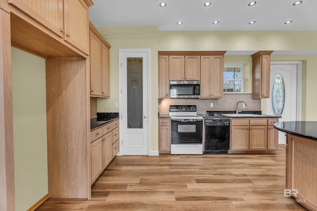 kitchen with stainless steel microwave, a sink, dishwasher, range with electric stovetop, and backsplash