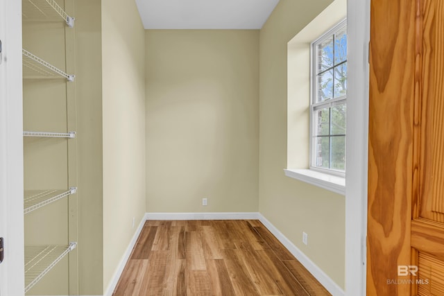 interior space with baseboards and wood finished floors