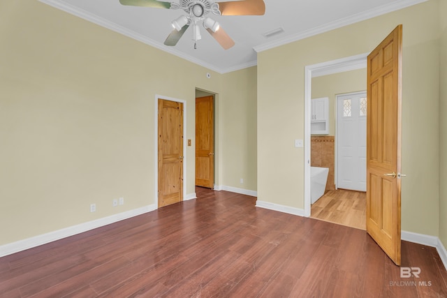 unfurnished bedroom with baseboards, ornamental molding, visible vents, ceiling fan, and wood finished floors
