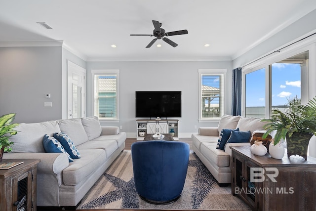 living area featuring visible vents, recessed lighting, ceiling fan, and a wealth of natural light