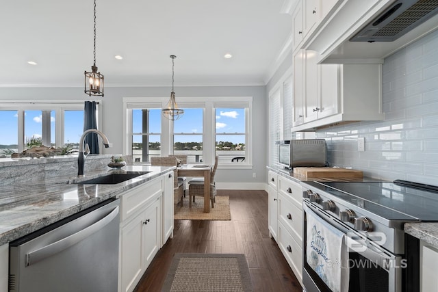 kitchen featuring a sink, appliances with stainless steel finishes, plenty of natural light, and extractor fan