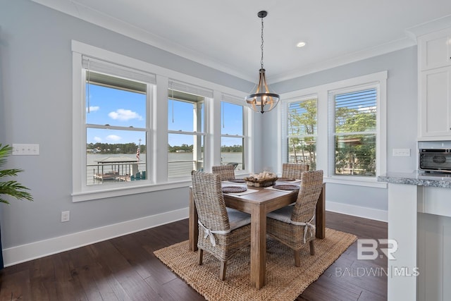 dining space featuring baseboards, a chandelier, ornamental molding, and a wealth of natural light