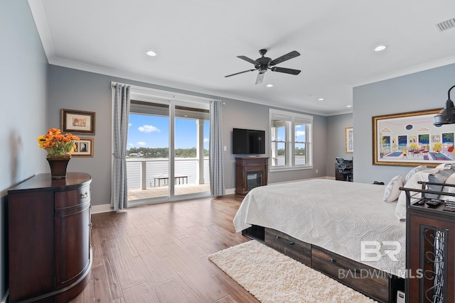 bedroom with access to outside, ornamental molding, baseboards, and wood finished floors
