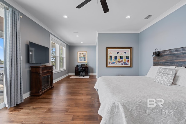 bedroom with recessed lighting, baseboards, wood finished floors, visible vents, and ornamental molding
