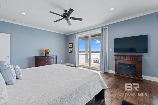 bedroom featuring baseboards, ornamental molding, access to exterior, and wood finished floors