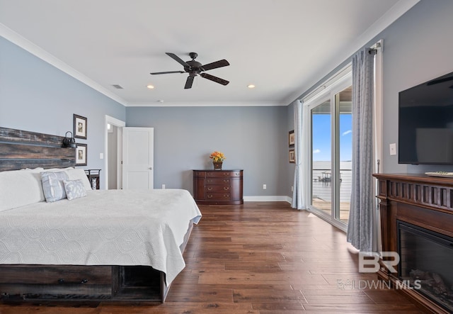 bedroom with dark wood-style flooring, visible vents, crown molding, access to exterior, and a glass covered fireplace