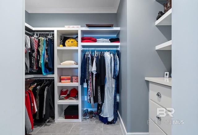 spacious closet with tile patterned floors