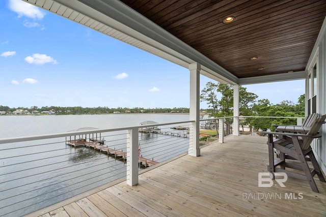 wooden deck featuring a water view