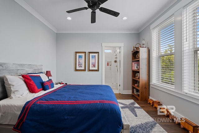 bedroom with baseboards, crown molding, wood finished floors, and multiple windows