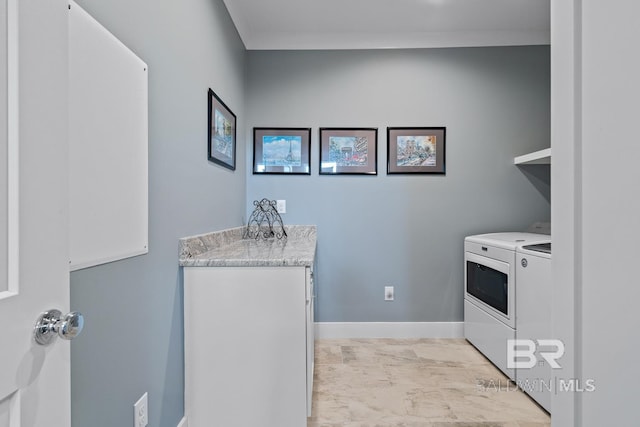 laundry area featuring baseboards, laundry area, and washer and dryer