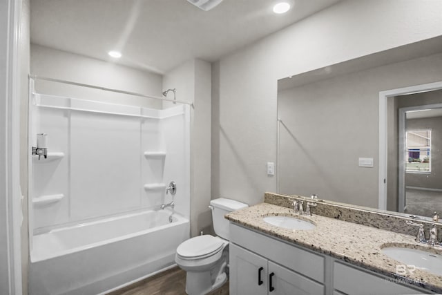 full bathroom with wood finished floors, toilet, shower / bathtub combination, and a sink