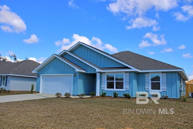 view of front of home with concrete driveway, board and batten siding, a shingled roof, an attached garage, and a front yard