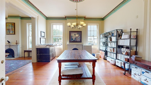 dining area featuring a notable chandelier, crown molding, and hardwood / wood-style flooring