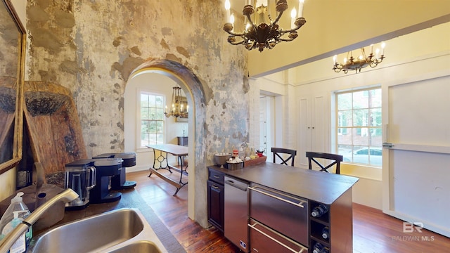 kitchen featuring dark hardwood / wood-style flooring, a notable chandelier, and sink