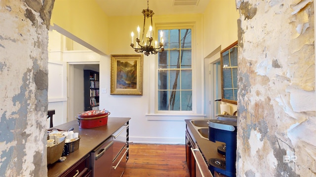 interior space with a chandelier, dark hardwood / wood-style floors, and sink