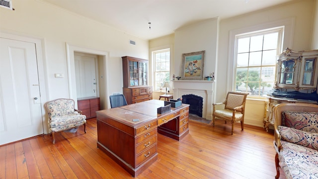 home office with light hardwood / wood-style flooring