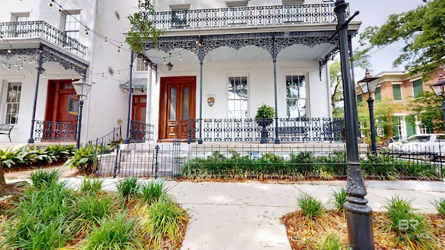 property entrance with a porch and a balcony