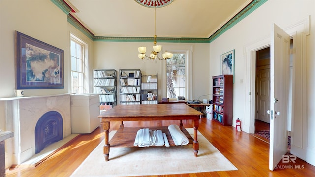 interior space featuring an inviting chandelier, crown molding, and hardwood / wood-style flooring