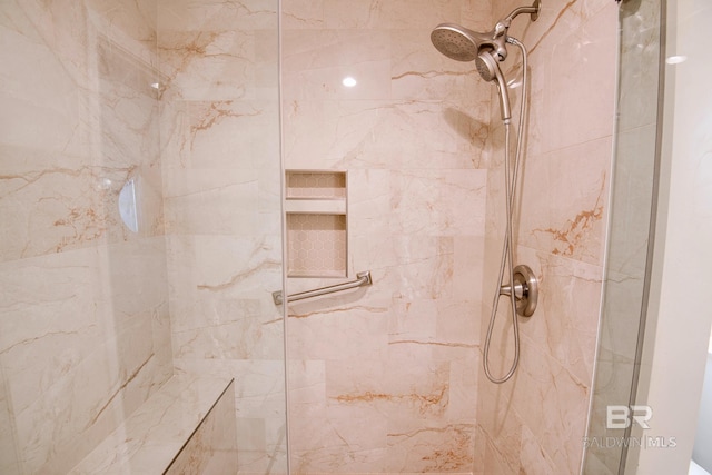 bathroom with tiled shower