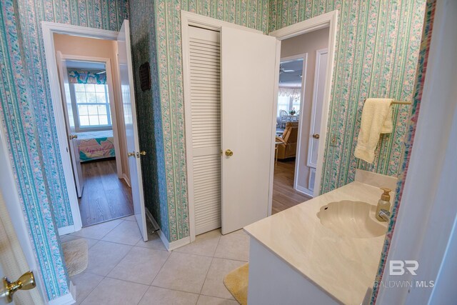 bathroom with a wealth of natural light, vanity, and tile patterned flooring