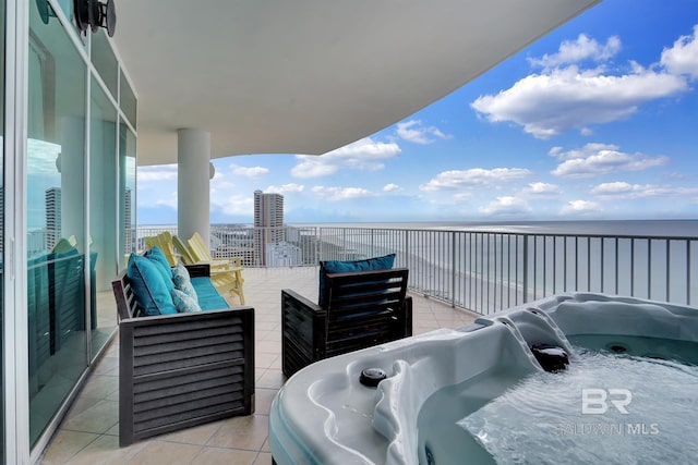 balcony featuring an outdoor living space and a water view