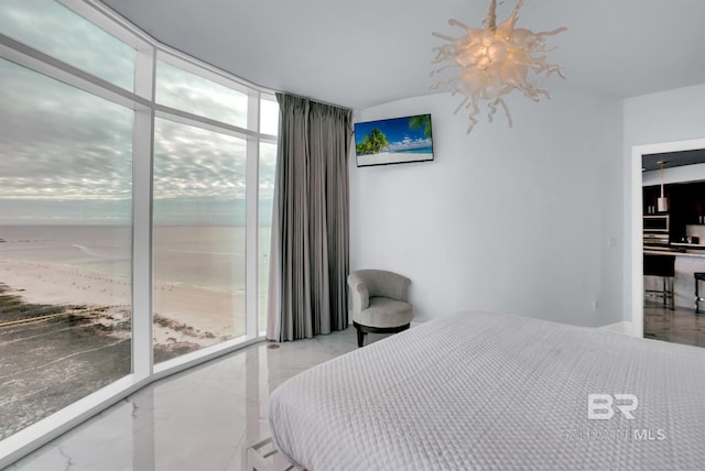 bedroom with an inviting chandelier, access to exterior, and expansive windows