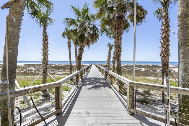 dock area with a water view and a view of the beach