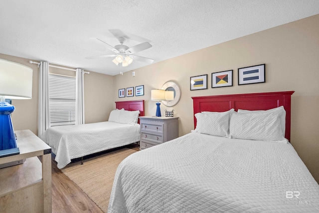 26802 Perdido Beach Blvd Unit 1008, Orange Beach, AL 36561 - bedroom with wood finished floors, ceiling fan, and a textured ceiling