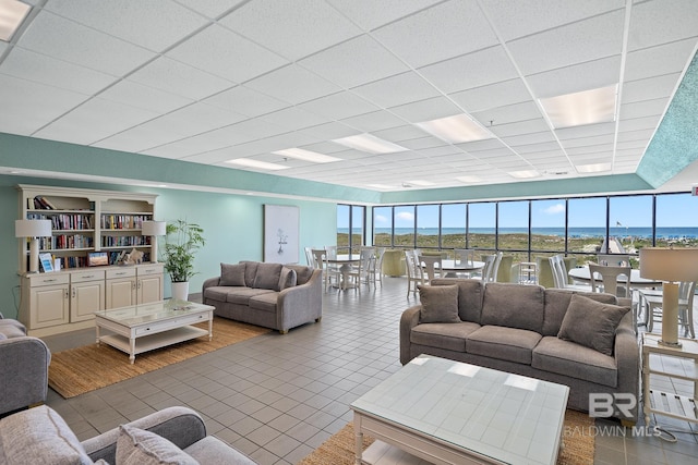 26802 Perdido Beach Blvd Unit 1008, Orange Beach, AL 36561 - living area with tile patterned floors, healthy amount of natural light, a drop ceiling, and expansive windows