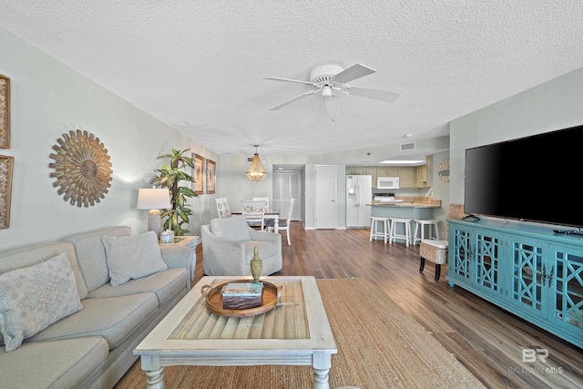 26802 Perdido Beach Blvd Unit 1008, Orange Beach, AL 36561 - living room featuring dark wood finished floors, ceiling fan, and a textured ceiling