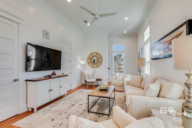 living room featuring ceiling fan and light hardwood / wood-style floors