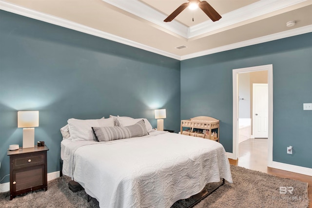 bedroom with ceiling fan, a tray ceiling, and crown molding