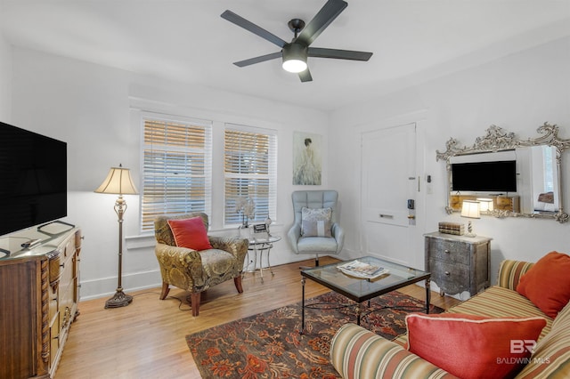 living room featuring light hardwood / wood-style floors and ceiling fan