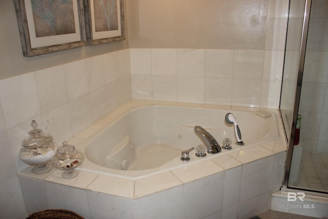 bathroom featuring shower with separate bathtub