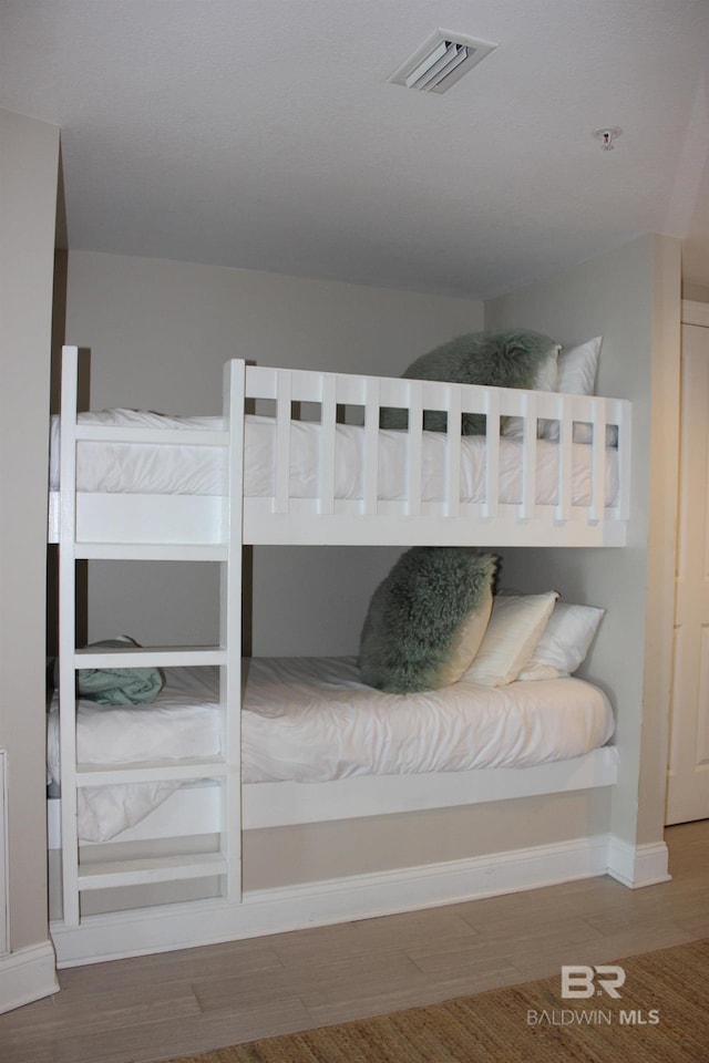 unfurnished bedroom with wood-type flooring