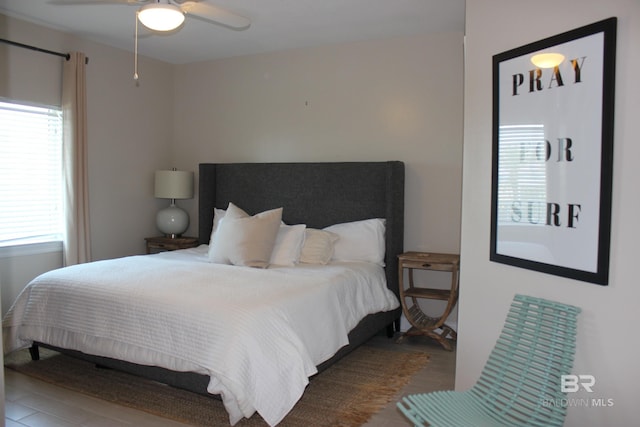 bedroom with ceiling fan and hardwood / wood-style flooring