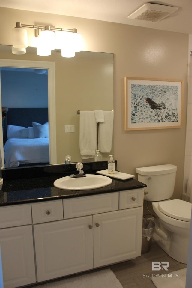 bathroom featuring large vanity and toilet