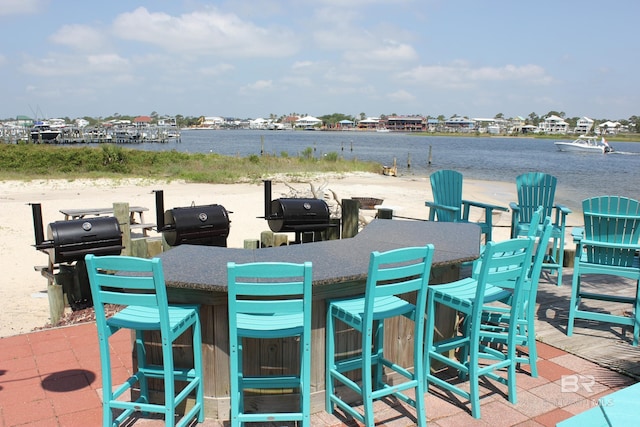 view of patio / terrace with an outdoor bar and a water view