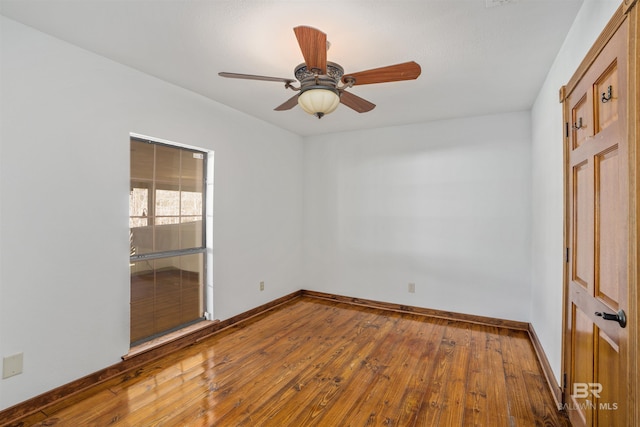 spare room with ceiling fan, baseboards, and wood finished floors