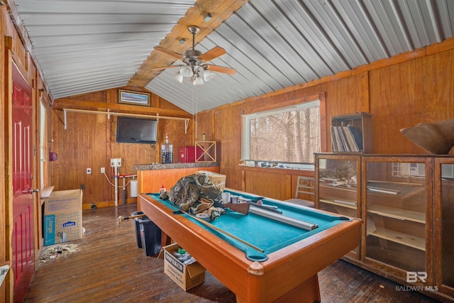 playroom featuring vaulted ceiling with beams, wood walls, a ceiling fan, and dark wood-type flooring
