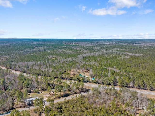 drone / aerial view featuring a forest view