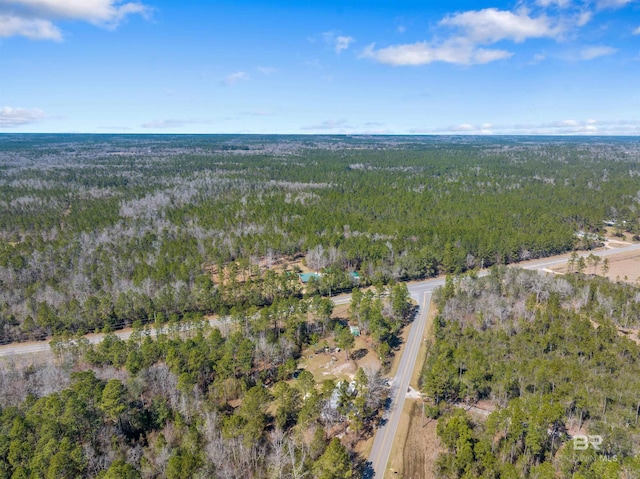 drone / aerial view featuring a view of trees